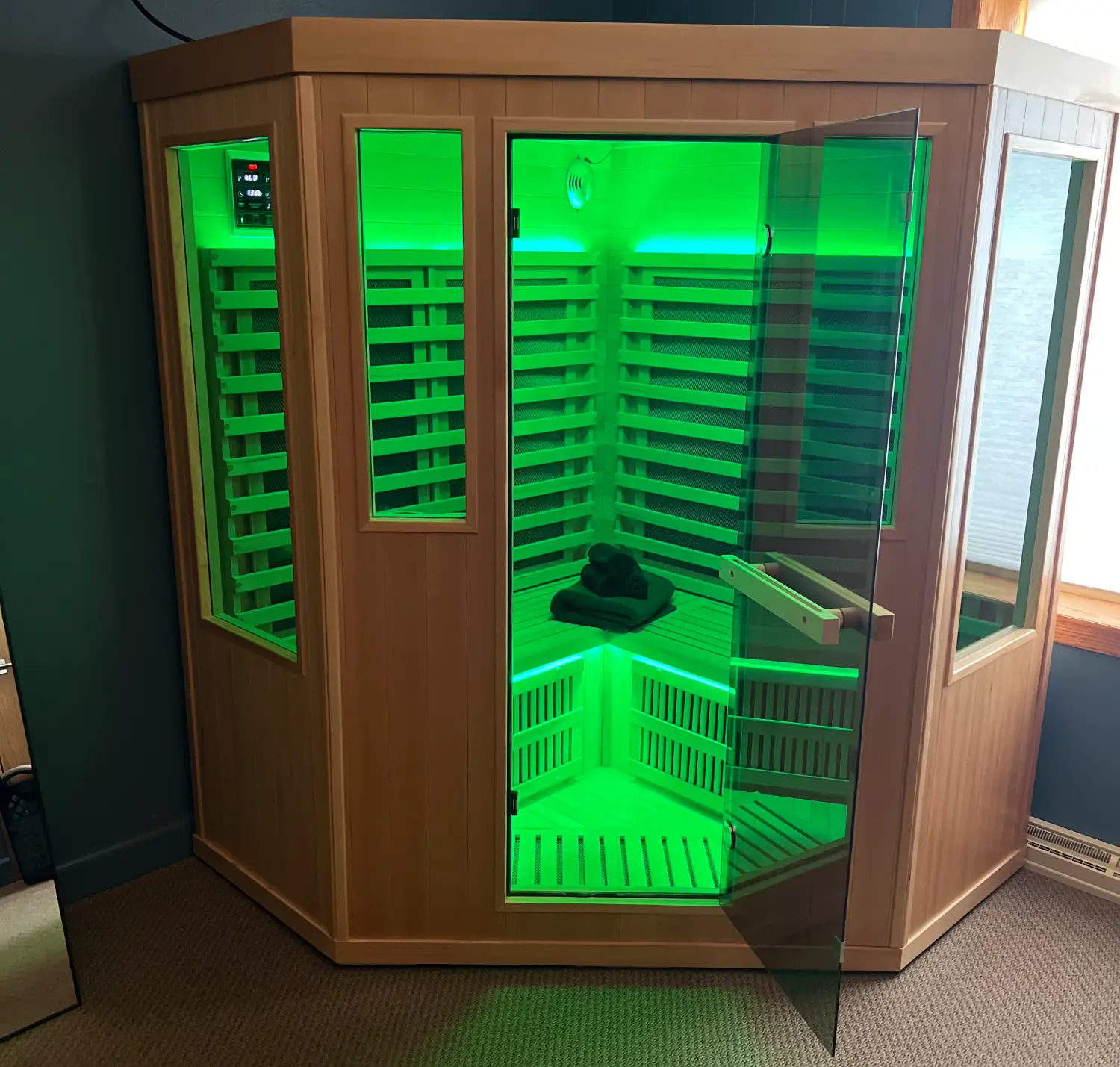 682db390832ae_Green Sauna door open A green light is on in the corner of this sauna.